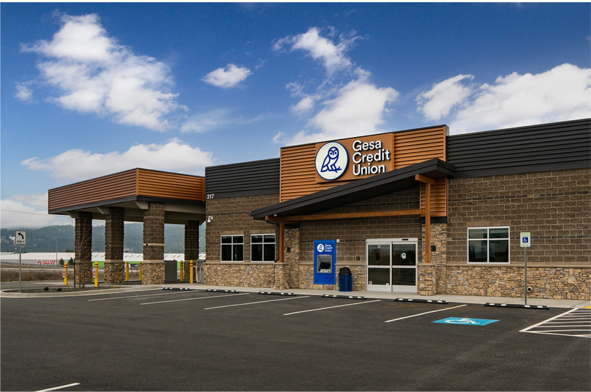 Brick Gesa Credit Union building with a parking lot in front.